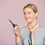 Flight Attendant Speaking to Portable Radio